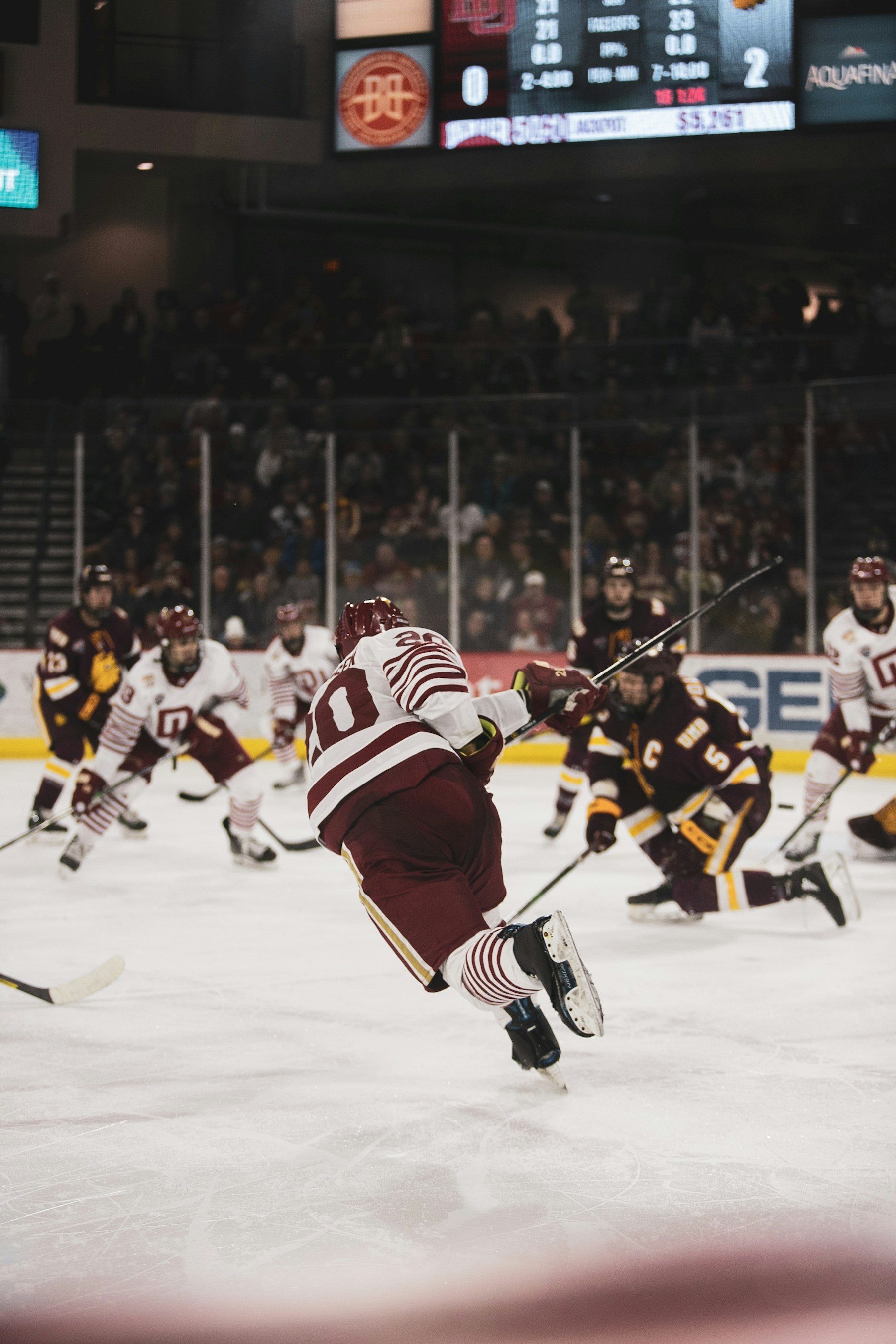 Ice hockey players beside rink shielding glass