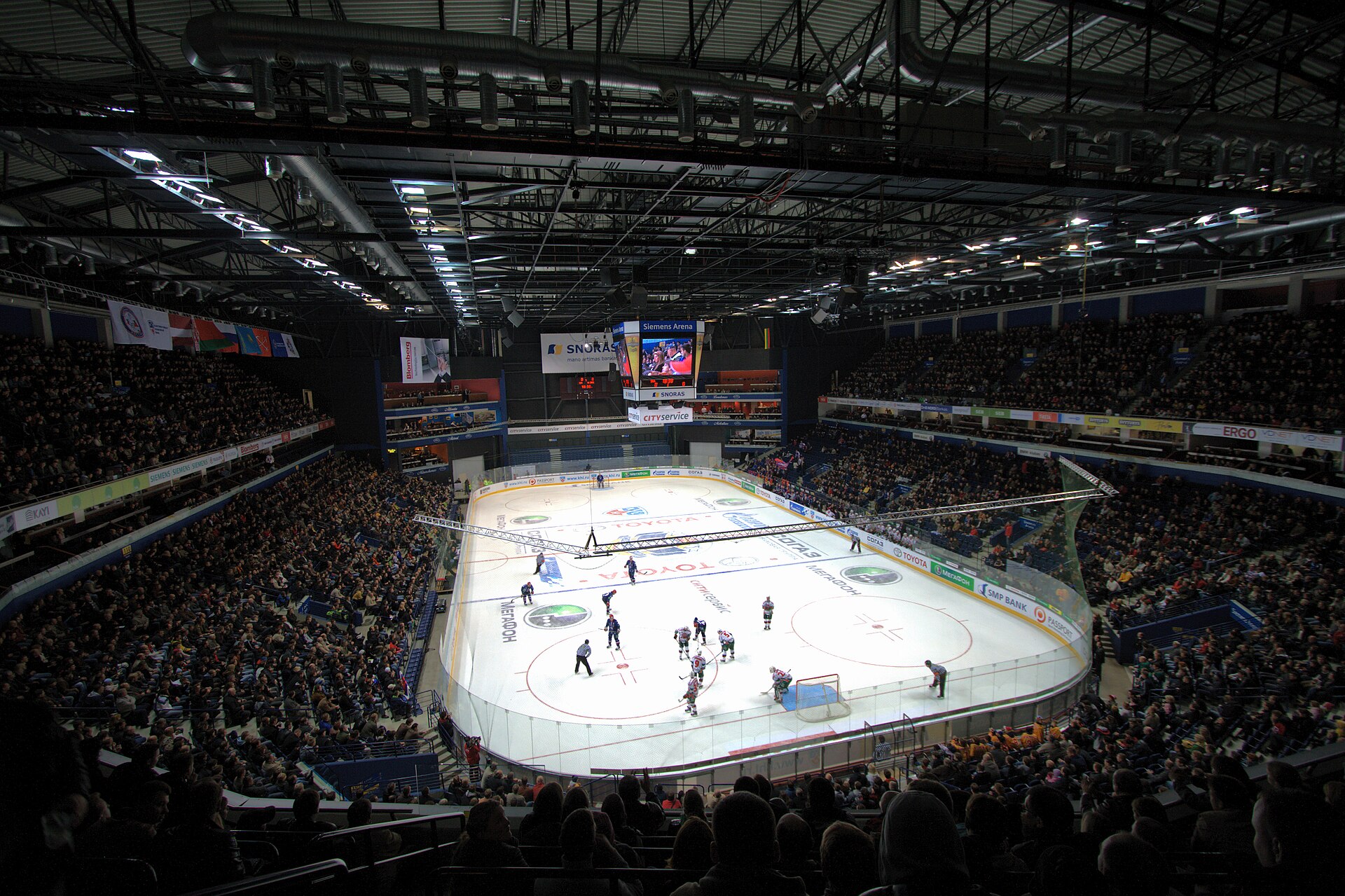 Full indoor ice hockey arena with rink surface and spectator seating