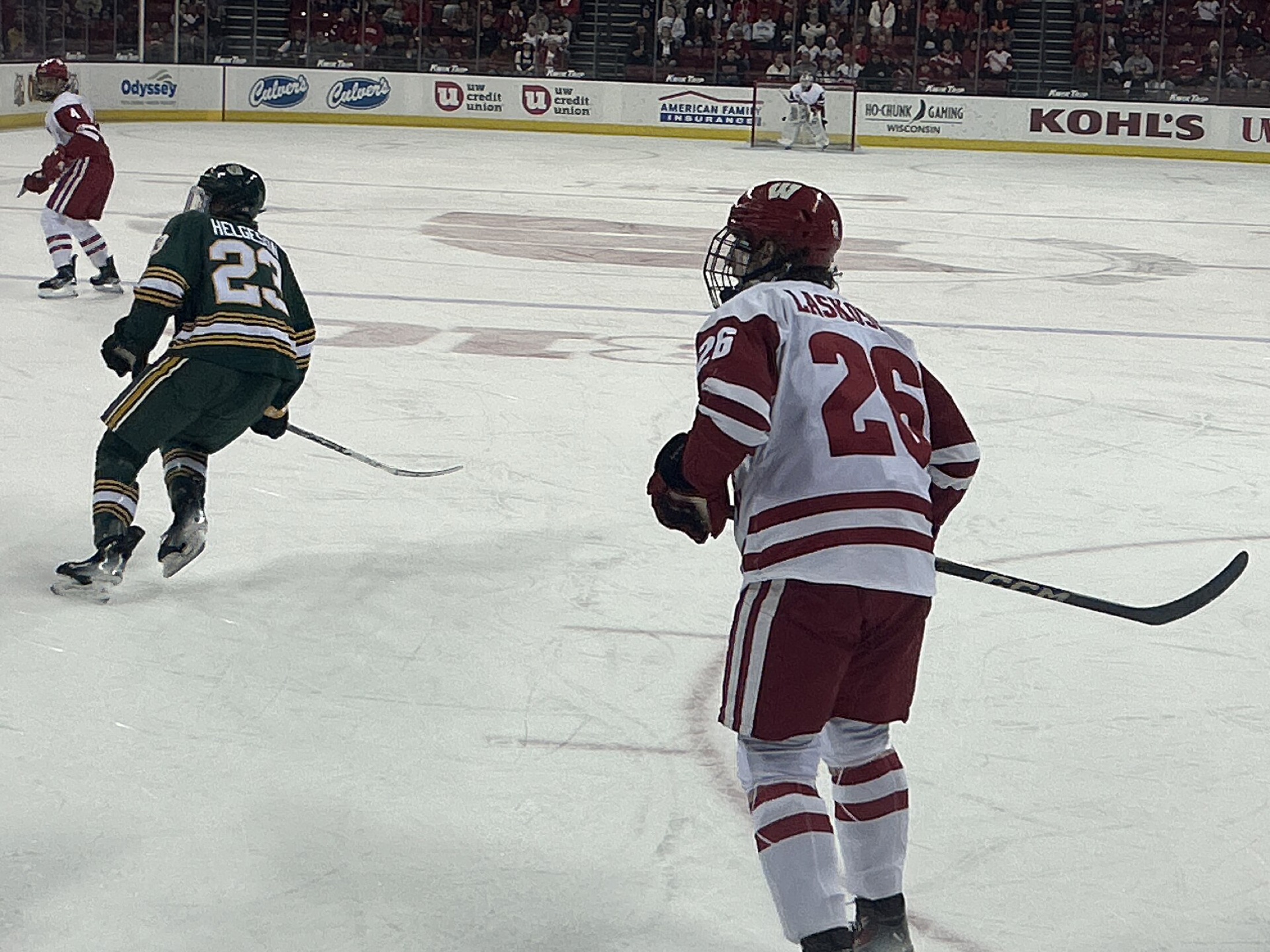 Hockey players competing on an indoor ice surface